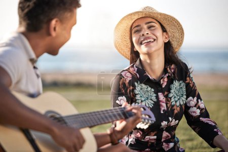 Photo for Happy, love and couple with guitar in nature for and romance, music and entertainment on date. Woman, smile and man with instrument by ocean coast for anniversary, bonding and adventure in Greece. - Royalty Free Image