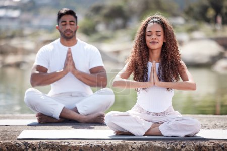 Photo for Ocean, meditation and couple with prayer hands for spiritual fitness, mental wellness and namaste. Beach, pilates and yogi woman with man with eyes closed for zen mindfulness, balanced chi or relax. - Royalty Free Image
