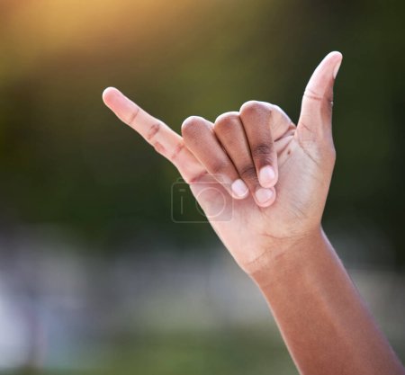 Photo for Outdoor, hand and shaka sign with person as gesture for thank you, greeting and opinion by closeup. Outside, emoji and signal by space as symbol for call me, contact and encouragement with mockup. - Royalty Free Image