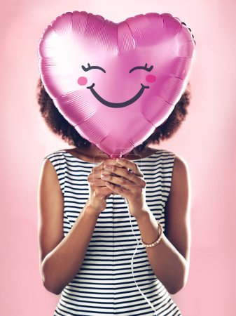 Photo for Girl, studio and heart shape balloon with smile for celebration, love and romance. Female person, anniversary and valentines day gift by pink background for surprise, present and announcement. - Royalty Free Image