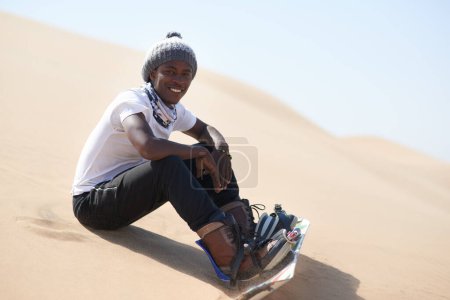Portrait, sandboarding and man with sunshine, smile and excited with fitness, summer and weekend break. Person, outdoor and guy with fun, happiness and recreation with hobby, exercise and wellness.
