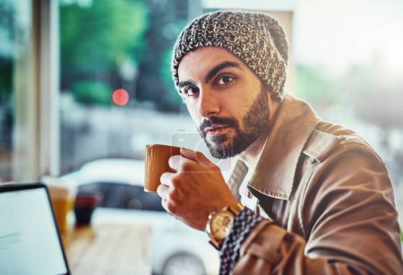 Foto de Portrait, journalist and man with coffee in cafe for online connection, typing article or information on blog. Editor, laptop and person with hot beverage for proof reading, remote work or report. - Imagen libre de derechos
