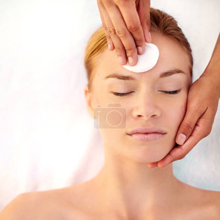Photo for Woman, massage and cotton pad for facial treatment, cosmetics and beauty therapy for skincare. Female person, calm and swab for hydration at resort for peace, dermatology and cleaning or grooming. - Royalty Free Image