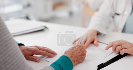 Photo for Hands, signature and doctor with patient and paperwork for healthcare and insurance. Talking, hospital and a medical employee with documents or a contract for a person while consulting for cardiology. - Royalty Free Image