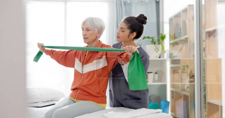 Photo for Senior woman doing a exercise with a resistance band for physiotherapy with a nurse in clinic. Fitness, healthcare and elderly female patient doing arm workout with therapist in rehabilitation center. - Royalty Free Image