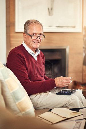 Photo for Calculator, portrait and senior man with notebook on sofa for expenses, monthly budget or pension in living room. Finance, smile and elderly person for income, insurance or retirement plan in home. - Royalty Free Image