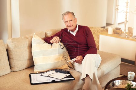 Photo for Portrait, documents and senior man with calculator on sofa for expenses, monthly budget or pension in living room. Finance, smile and elderly person for savings, insurance or retirement plan in home. - Royalty Free Image