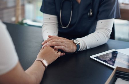 Photo for Doctor, patient and holding hands for healthcare support in hospital office with closeup, empathy and kindness. Professional, expert and woman with sympathy for medical results, diagnosis and health. - Royalty Free Image