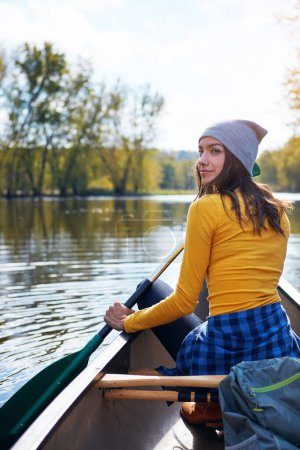 Woman, water and thinking on lake canoeing, wellness hobby and single blade paddle for rowing. Vacation, relax and explore exercise on travel in summer, canoe boat and trees on river for fitness.