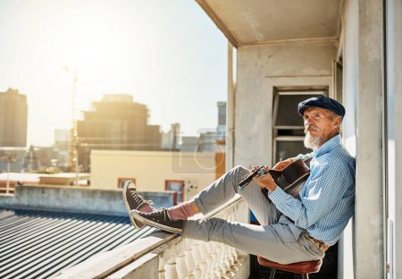 Artist, senior and man with acoustic guitar for playing with retired musician on balcony in town for memories. Elderly, creative and proud of accomplishments with blues or folk song in urban Italy