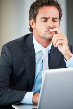Business man, thinking and decision on laptop for corporate investment, risk or stock market research in office. Confused corporate worker, trader or investor reading on computer with doubt or worry.
