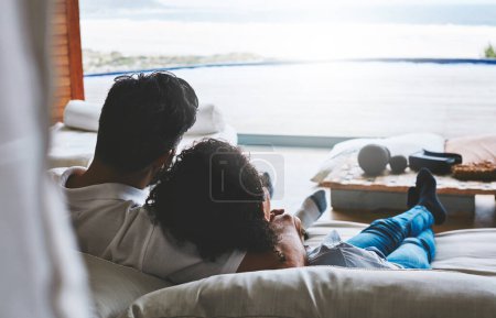 Couple, people and back in home on couch to relax for bonding, love and support on break together. Living room, relationship and hug in sofa as family, soulmate and care to enjoy with trust in lounge.
