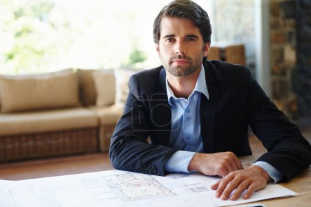 Photo for Portrait, business man and serious with blueprint for planning, building design or floor plan on desk. Home office, architecture or male architect for project renovation, real estate or ideas. - Royalty Free Image