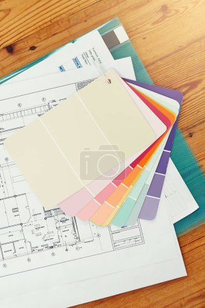 Photo for Color, swatch and planning home renovation with blueprint on table from above with interior design. Creative, moodboard and decision for project in house with sketch of floor plan on desk in office. - Royalty Free Image
