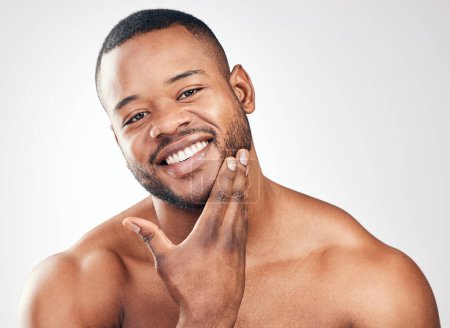 Photo for Skincare, portrait and black man in studio for wellness, healthy skin and pamper with cosmetics. Male model, hand and natural glow for beauty, treatment results and confidence by white background. - Royalty Free Image