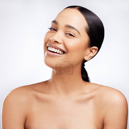 Skincare, woman and portrait for wellness, aesthetic and routine facial treatment. Spa, smile and skin glow for dermatology on white studio background with black model, cosmetics and collagen shine.