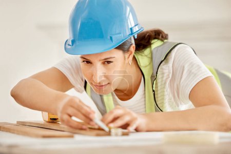 Photo for Construction, woman and plank on table to measurement, accuracy and check size for inspection. Architecture, contractor and blueprint for floor plan, equipment and renovation project in office. - Royalty Free Image