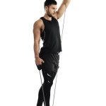 Man, studio and workout with resistance band for training or wellness, fitness and exercise for bodybuilder. Male athlete, strong body and elastic for muscle, white background with gym in New Zealand.
