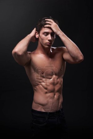 Sexy, skin and man in studio for exercise with fitness goals, confidence and progress results for training abs. Guy, athlete or bodybuilder and torso with muscle and strong body by black background.