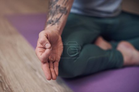 Téléchargez les photos : Hands, meditate or person in home for yoga, wellness or spiritual mudra in lotus pose or zen gyan. Relax, tattoo or closeup of yogi on mat for mindfulness, calm peace or balance in pilates session. - en image libre de droit