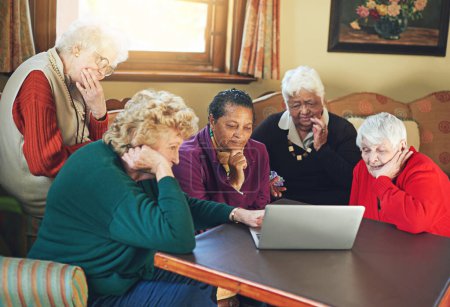 Foto de Nursing home, senior people and laptop in living room for entertainment, online game and social media. Retirement, community and technology with internet together for communication and streaming. - Imagen libre de derechos