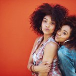 Girls, friends and portrait or fashion in studio with casual style, trendy outfit and mockup space on red background. Women, people and smile in city with streetwear, afro and pout in edgy clothes.