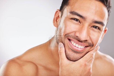 Photo for Portrait, skincare and man with beauty, smile and dermatology on white studio background. Face, person and model with cosmetics, aesthetic and grooming routine with shine, glowing and healthy skin. - Royalty Free Image
