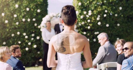 Bride, wedding and walking by aisle with marriage, commitment and love for groom or partner. Woman, ceremony and processional entrance for matrimony, loyalty and union outdoor with audience or crowd.