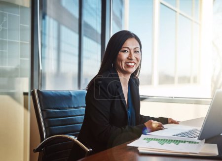 Japanese woman, documents and laptop for graphs, review and smile in portrait at financial agency. Person, accountant or happy in office for budget, audit and charts for performance, growth or stats.