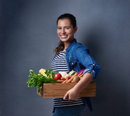 Studio, farmer or girl in portrait with vegetables, nutrition and fresh products in basket by mockup. Small business, organic or harvest with female supplier, agriculture and food by gray background.