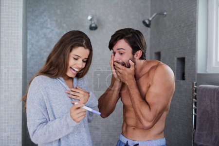 Couple, pregnancy test and surprise for results in home, maternity kit and happy for outcome in bathroom. People, together and support to check for baby news, wow and ivf success for fertility stick.
