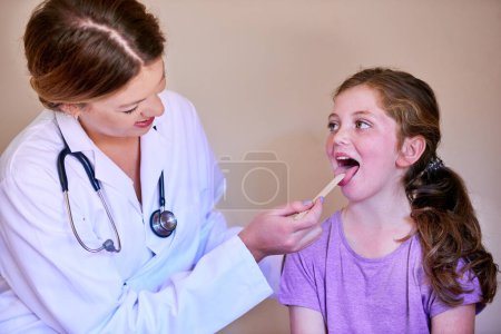 Depresor, niño y médico revisan la boca en busca de bienestar, prueba o atención médica de las personas en el hospital médico. Examen de la lengua, amígdalas u otorrinolaringología del niño, pediatra o garganta con el paciente.