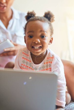 Girl child, portrait and relax with laptop in home for creative activities, early learning and streaming movies. Toddler, online and technology for curiosity or engaging for growth or development