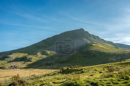 A panoramic mountain view of Y Garn mountain from the fishing lake of Llyn Dywarchen in the Eryri National Park, Wales, UK.