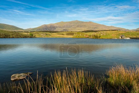 Panoramic views from the fishing lake Llyn y Dywarchen with a backdrop of Yr Wyddfa in the Eryri National Park, Wales, UK.