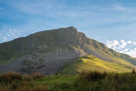 A panoramic mountain view of Y Garn mountain from the fishing lake of Llyn Dywarchen in the Eryri National Park, Wales, UK.
