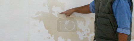 Photo for Image of a construction engineer illustrating damage to a brick wall due to moisture issues. Repair due to rising damp. Horizontal banner - Royalty Free Image