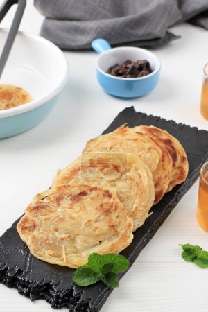 Photo for Roti Canai or Paratha Parotta Flat Bread, Also Known as Roti Maryam in Indonesia. Can Served with Curry or Sweet Topping - Royalty Free Image