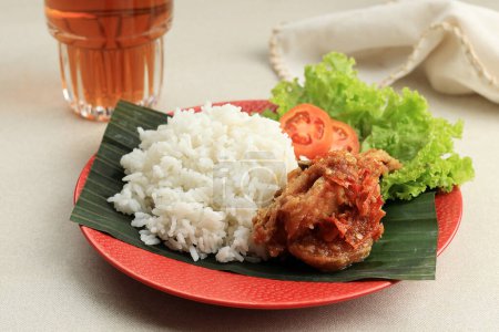 Photo for Close Up Ayam Penyet. Deep Fried Chicken Served with Sambel or Sambal, Spicy Chilli Sauce.  Ayam Penyet or Ayam Geprek is Traditional Indonesian Cuisine - Royalty Free Image