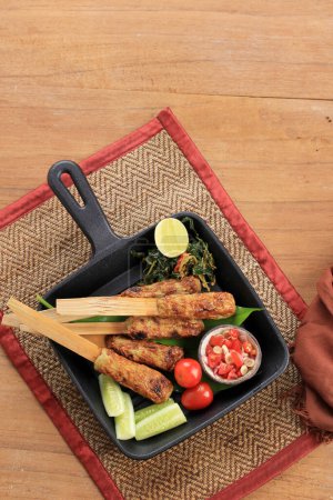 Foto de Top View Sate Lilit, Balinese Menu. Minced Seafood Satay Made from Tuna Fish and Other Ingredients with Bamboo Handle - Imagen libre de derechos