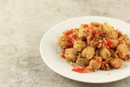 Photo for Tahu Lada Garam or Tahu Cabe Garam, Crispy Fried Cubed Tofu with Chilli, Garlic, and Pepper. Vegan Food Concept. Copy Space for Text or Advertisement - Royalty Free Image