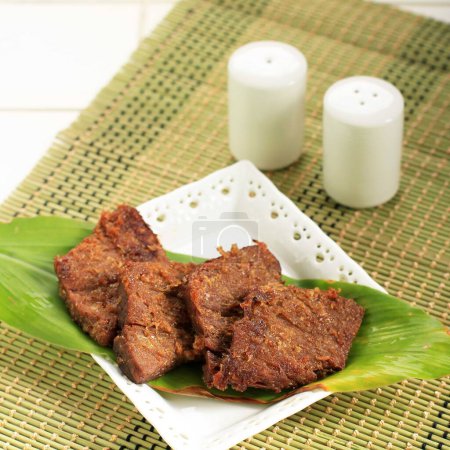 Photo for Empal or Gepuk is Indonesian Fried Meat with Traditional Herb and Spiced. It Taste Sweet, Tasty, Tender, and Delicious. Usually Served with Sambal and Rice - Royalty Free Image