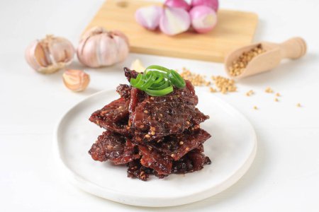 Photo for Dendeng Sapi is Indonesian Style Beef Jerky, Thin Slice Meat Processed, Sun Dried and Marinated with Sweet Spice and Coriander - Royalty Free Image