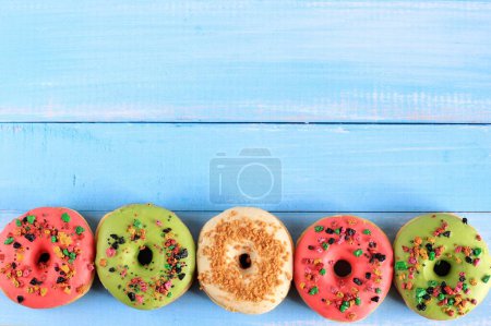 Photo for Top View Assorted Doughnut with Colorful Sprinkle Isolated on Blue Wooden Background, Copy Space for Text - Royalty Free Image