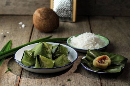 Photo for Katimus, Indonesian Sundanesse Traditional Snack made from Steamed Cassava, Wrapped with Banana Leaf and Stuffed with Palm Sugar - Royalty Free Image