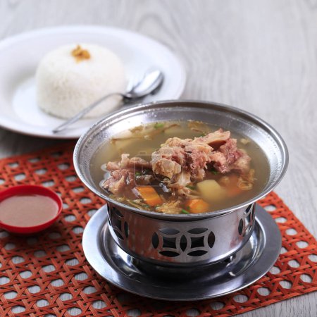 Photo for Sop Buntut Oxtail Soup with Potato and Carrot Served with White Rice, on the Table - Royalty Free Image