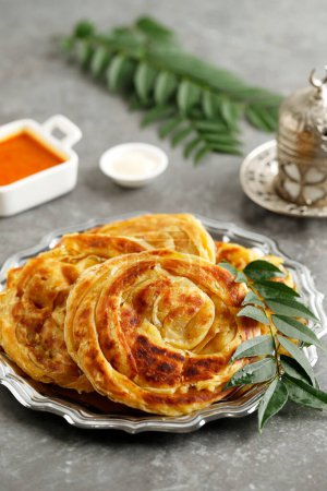 Photo for Roti Parata or Roti Canai with Chicken Curry Sauce, Popular Dish in Malaysia and Indonesia - Royalty Free Image