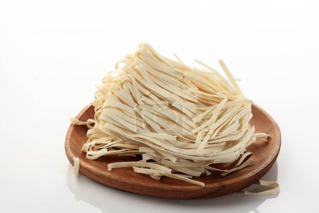 Photo for Dried Kwetiaw or Char Kway Teow on Wooden Plates, Isolated on White Background. Chinese Rice Noodle - Royalty Free Image