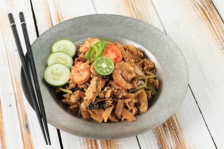Photo for Stir Fried Chinese  Flat Rice Noodle or Char Kway Teow or Kwetiau with Seafood, Famous Food among Indonesian, Malaysian, and Singaporean - Royalty Free Image