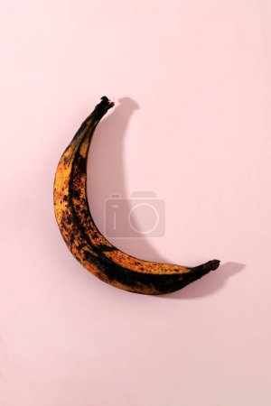 Photo for Top View Over Ripe Rotten Banana on Pink Background - Royalty Free Image